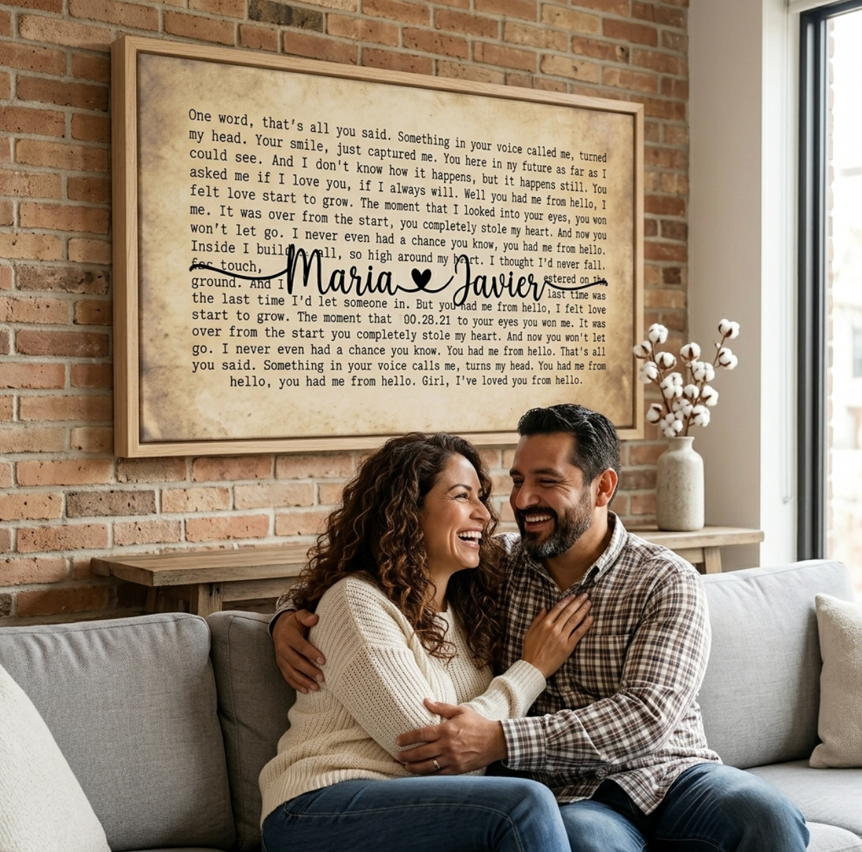 Custom song lyrics canvas with modern black floating frame held by newlywed couple