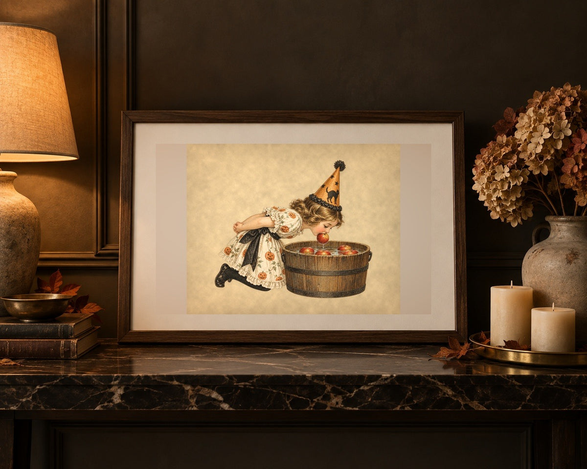 Vintage Halloween apple bobbing print framed in dark walnut on a marble console with dried hydrangeas