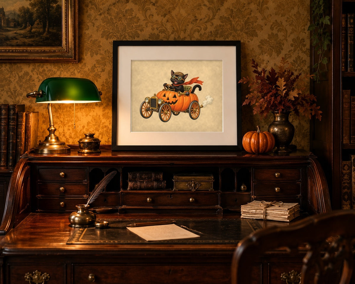 Framed black cat jack-o'-lantern car print on a roll-top desk with a banker's lamp