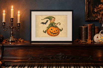 Vintage Halloween goblin print in a black frame on an antique piano with a candelabra and white ghost pumpkin