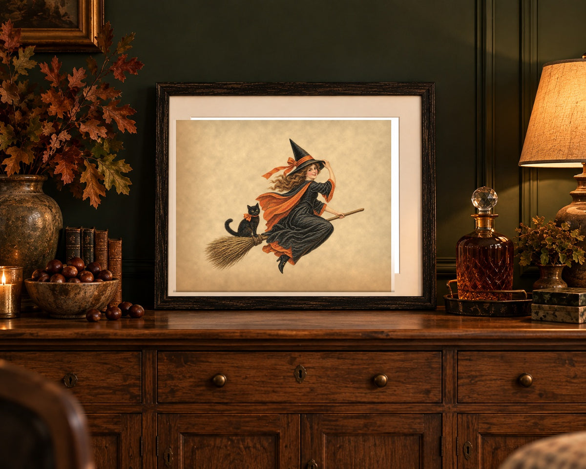 Vintage Halloween witch print framed on an oak sideboard against a forest green wall