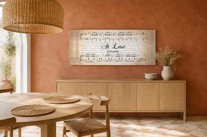 At Last panoramic lyric canvas on a terracotta limewash wall above a light oak sideboard in a bright boho dining room