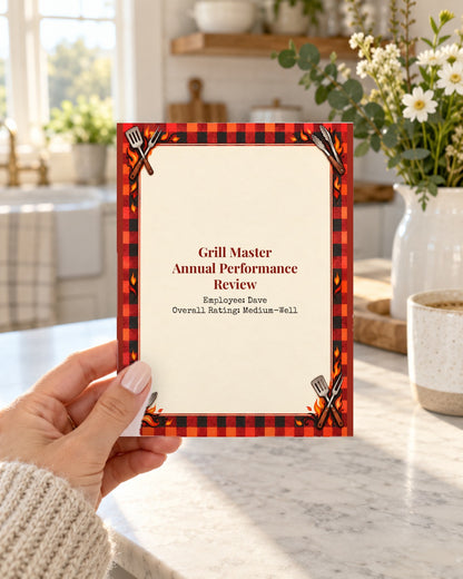 Hand holding a funny grill master performance review birthday card
