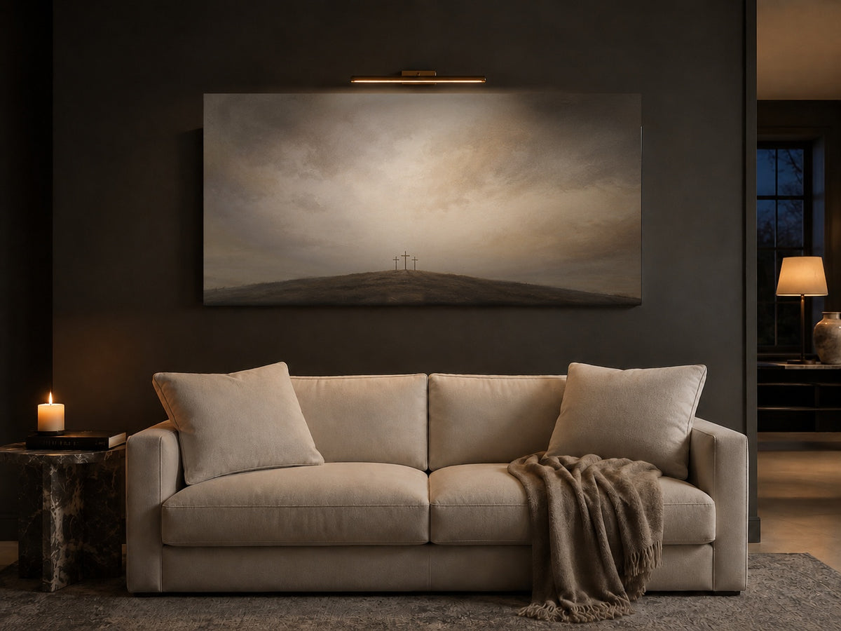 Three Crosses at Calvary canvas above a cream linen sofa in a charcoal living room