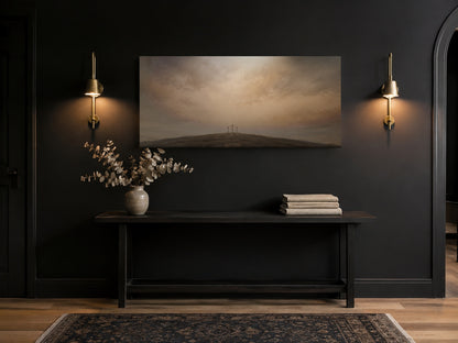 Three Crosses at Calvary canvas in a black entryway with brass sconces and console table