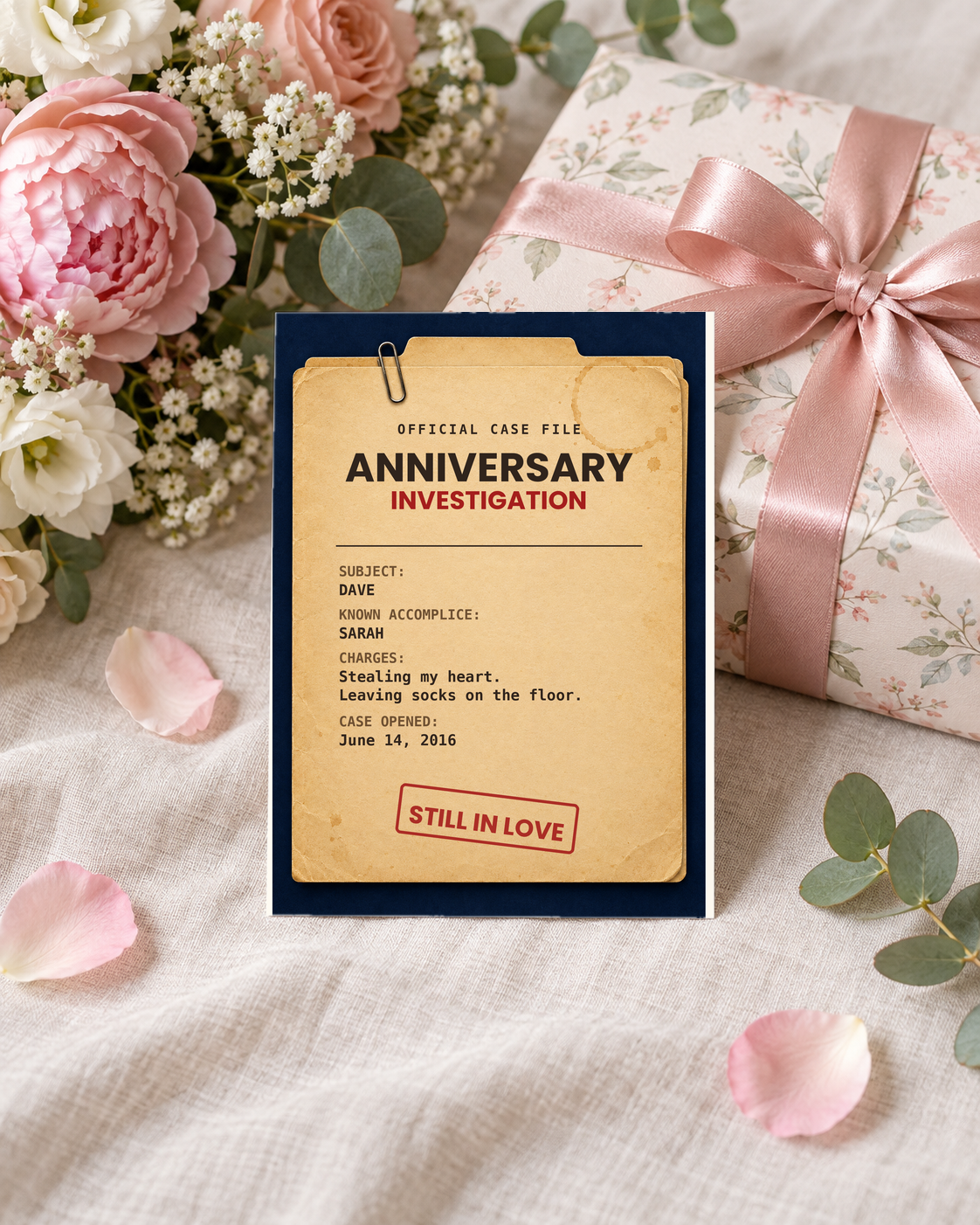 Case file anniversary card leaning on a wrapped gift