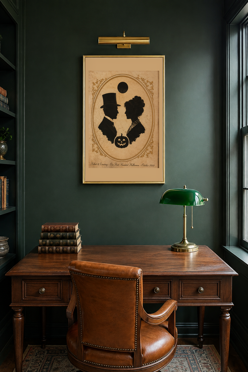 Custom Edwardian silhouette Halloween anniversary print in a gold frame on a deep forest green study wall above a walnut writing desk with a cognac leather chair and green banker's lamp