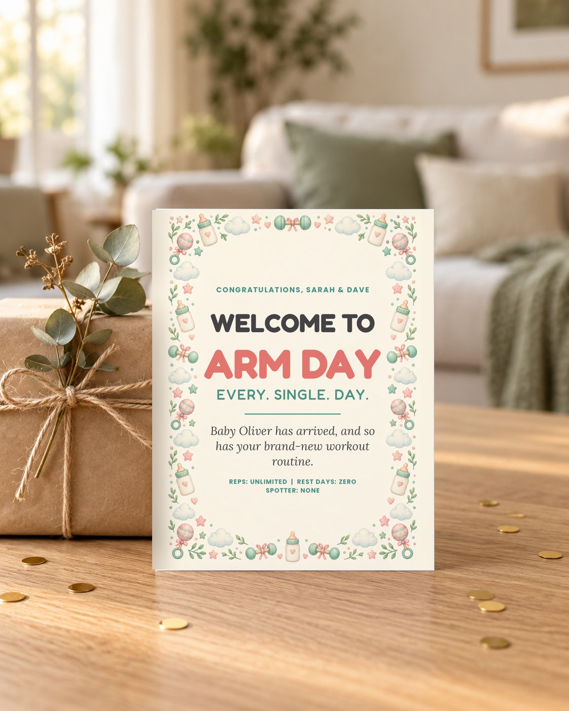 Arm Day new baby card leaning on a wrapped gift