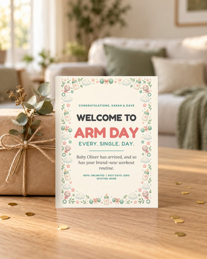 Arm Day new baby card leaning on a wrapped gift