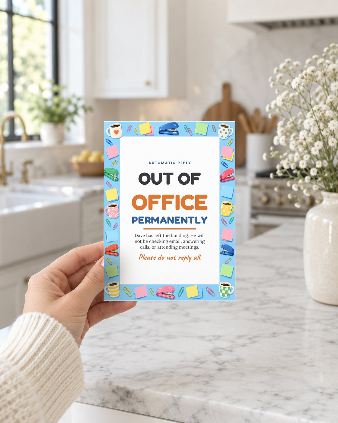 Hand holding the out of office leaving card in a bright kitchen