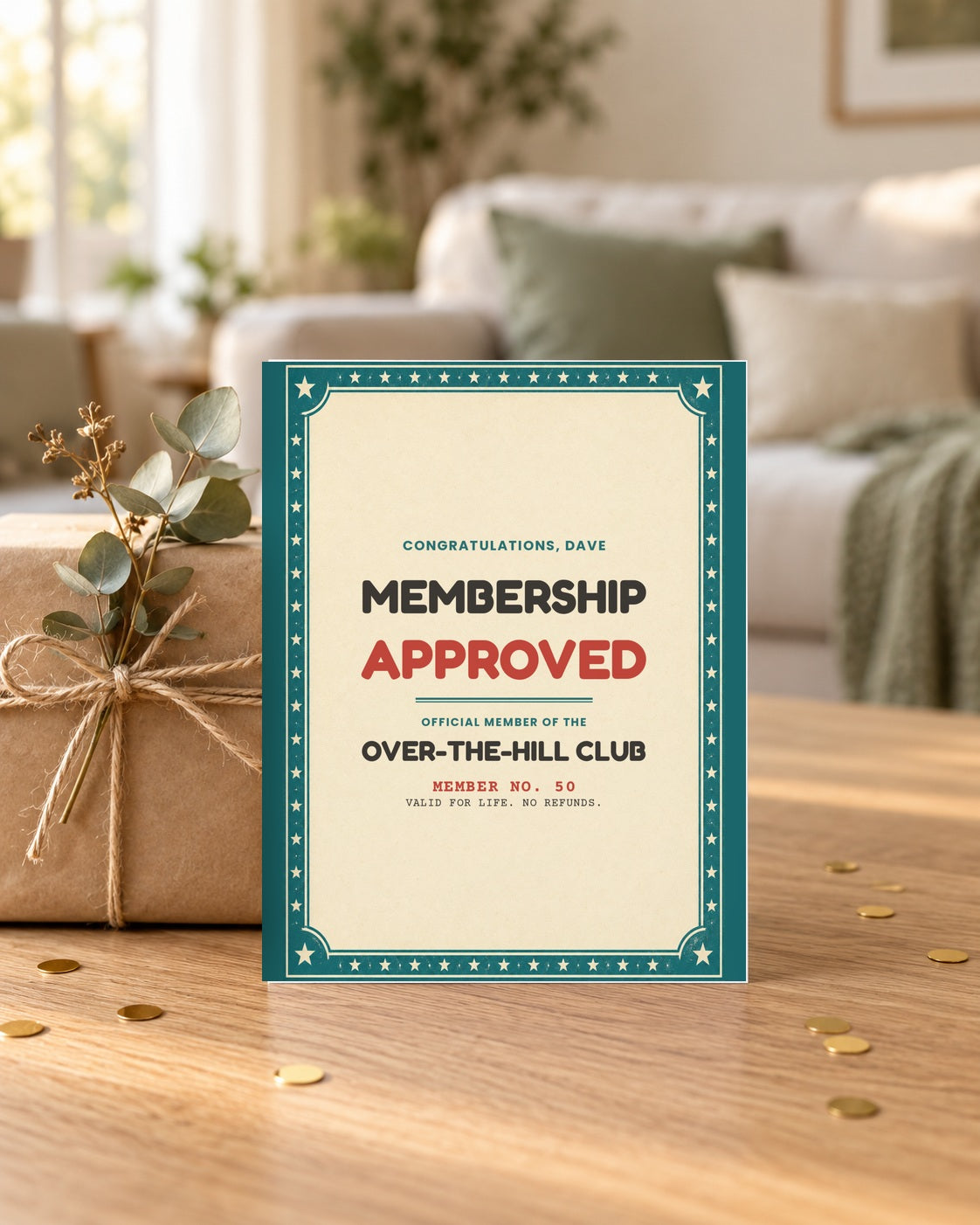 Membership approved birthday card leaning on a wrapped gift