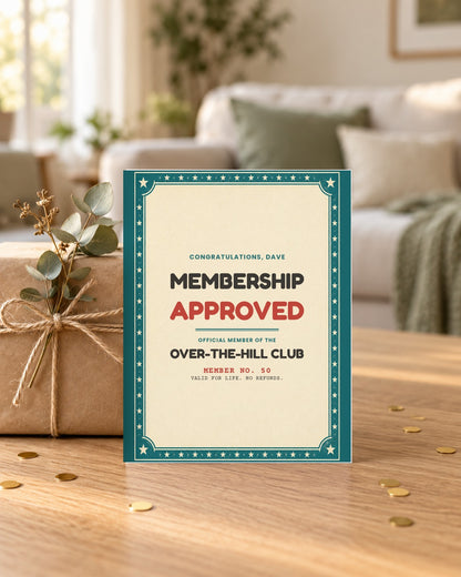 Membership approved birthday card leaning on a wrapped gift
