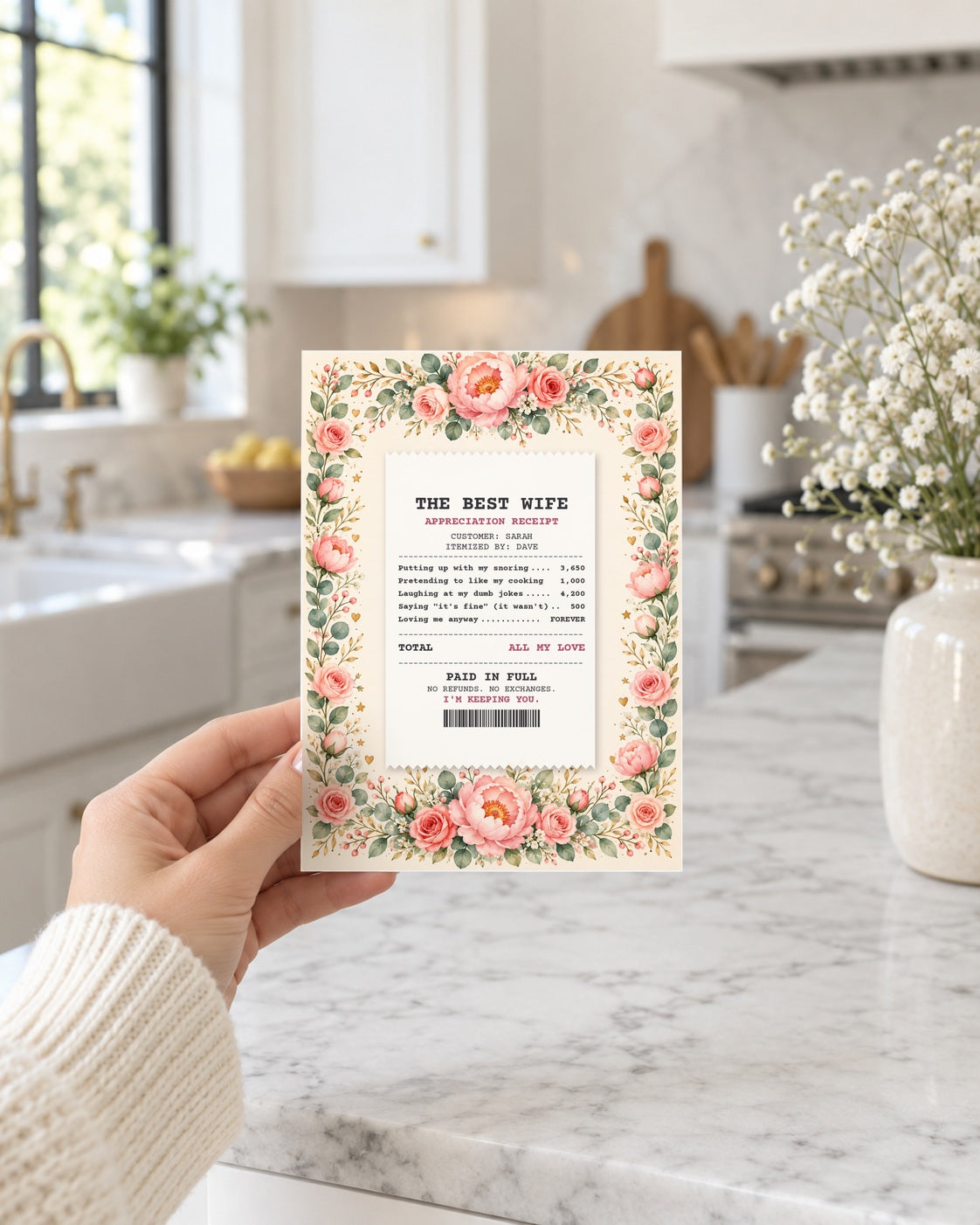 Hand holding the wife receipt card in a bright kitchen