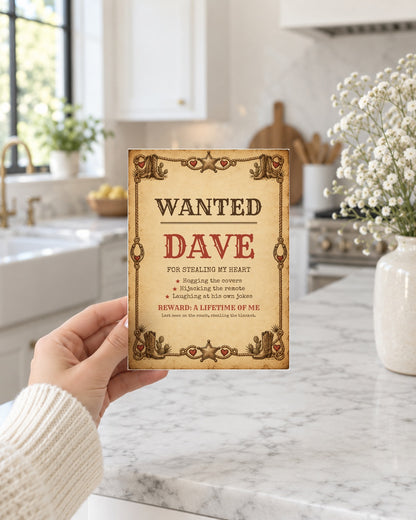 Hand holding the wanted poster card in a bright kitchen