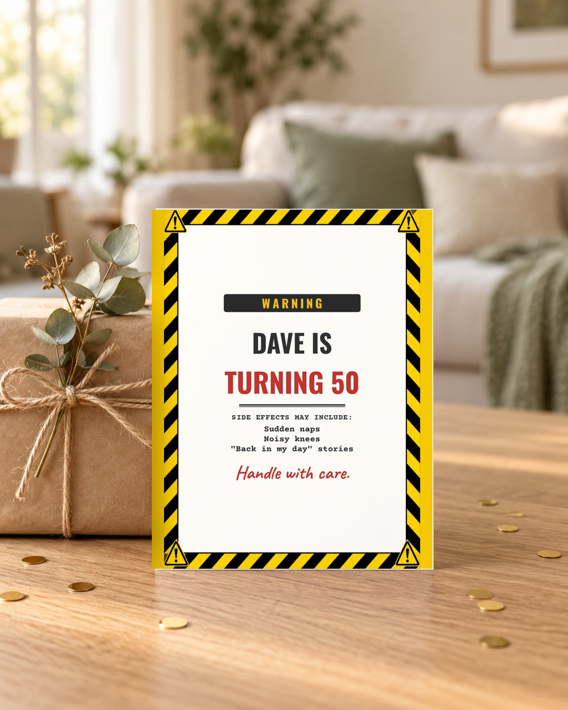 Warning label birthday card leaning on a wrapped gift