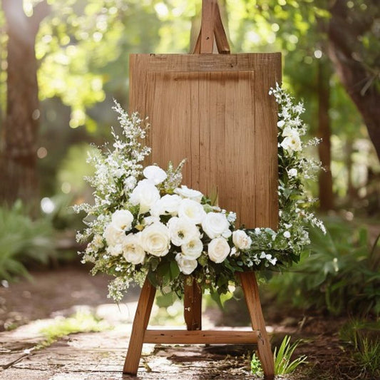 Rustic wood wedding welcome sign on easel with florals