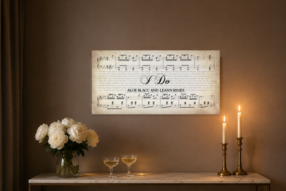 I Do song lyrics canvas above a marble console with white peonies, champagne coupes and brass taper candles at night
