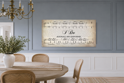 I Do song lyrics canvas on a dusty blue panelled dining room wall above a round oak table with cane chairs