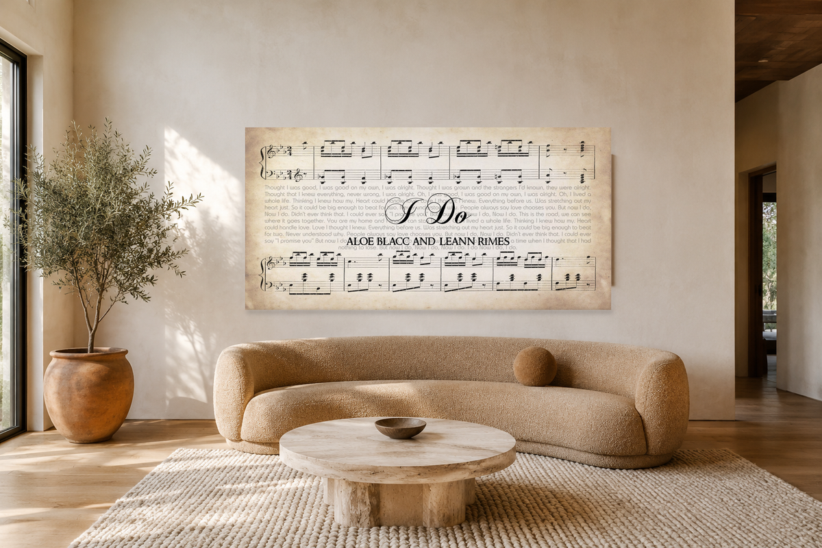 I Do song lyrics panoramic canvas hanging above a curved boucle sofa in a sunlit cream limewash living room