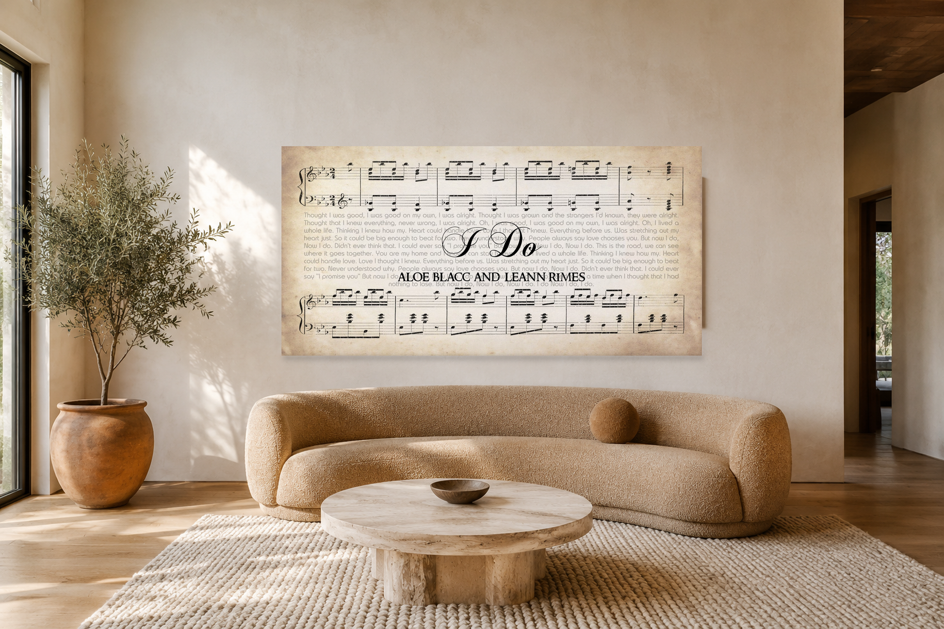 I Do song lyrics panoramic canvas hanging above a curved boucle sofa in a sunlit cream limewash living room