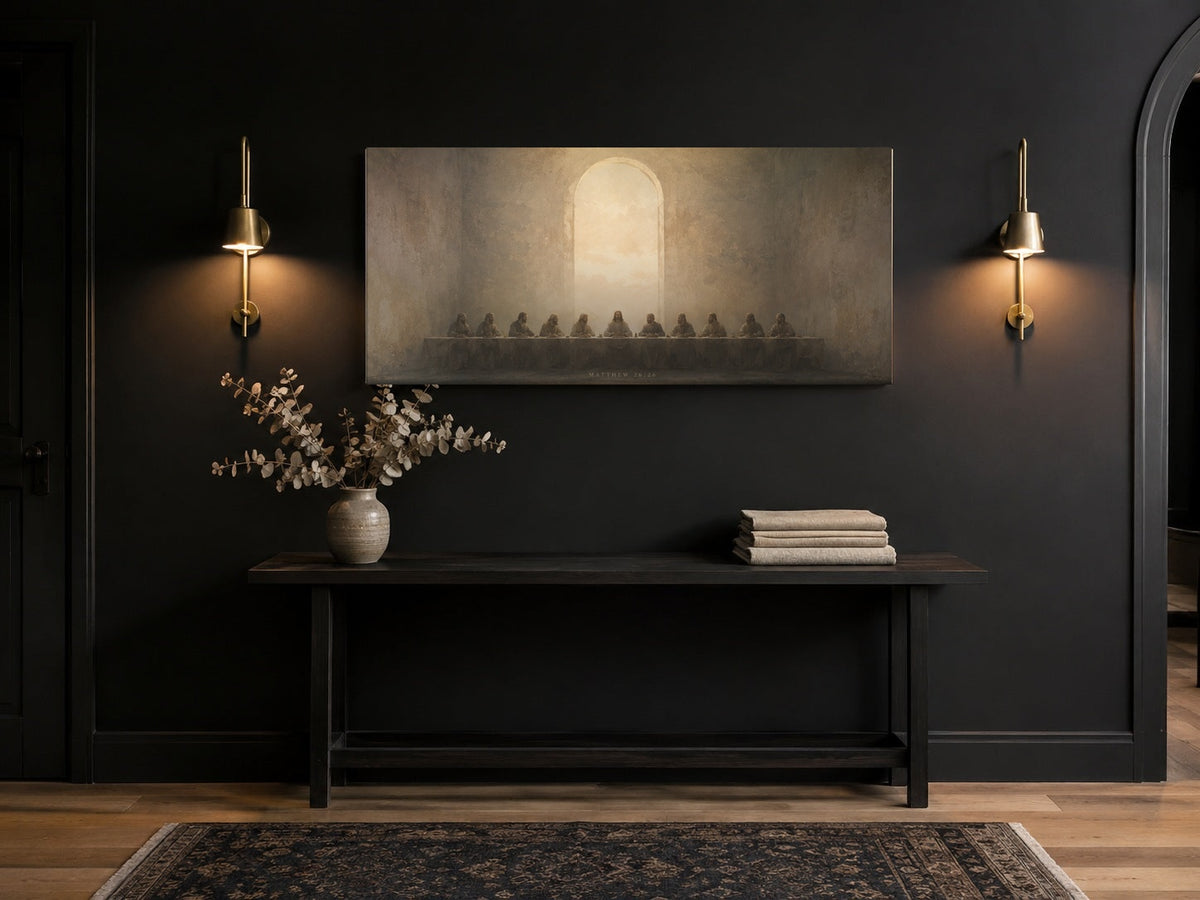 Last Supper canvas in a black entryway with brass sconces and console bench