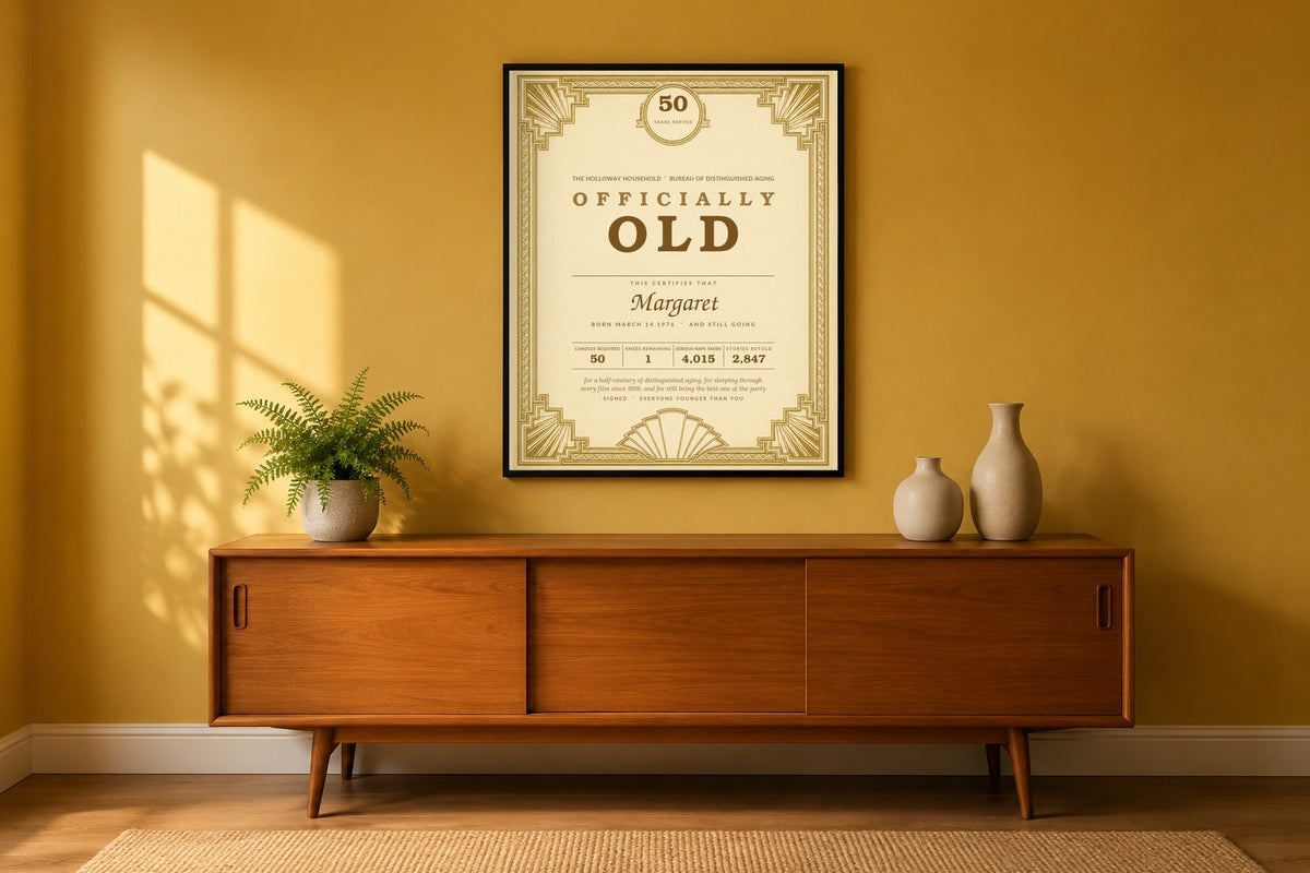 Personalized funny 50th birthday certificate framed on a mustard living room wall