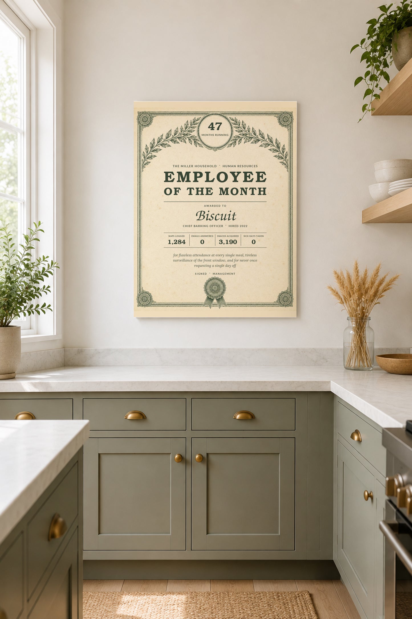 Pet award print in a bright kitchen above sage green cabinetry