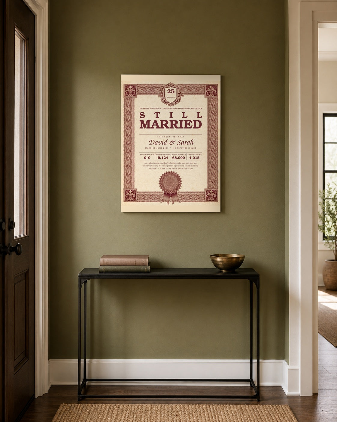 Funny anniversary gift certificate print on an olive green hallway wall above a console table