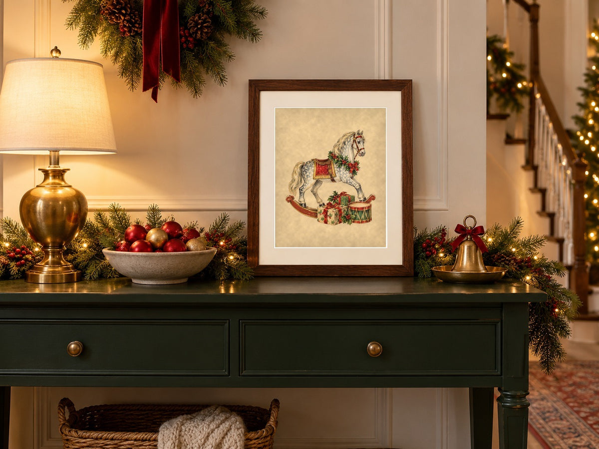 Vintage Christmas rocking horse print framed on a green entry console with ornaments