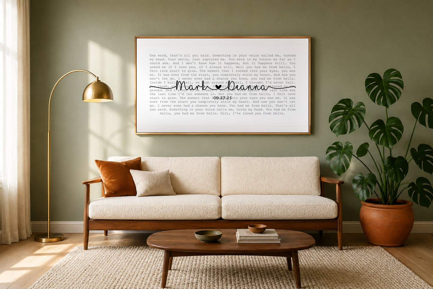Custom song lyrics canvas hanging above a mid-century sofa in a sage green living room