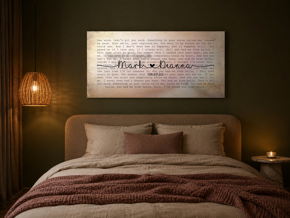 Custom names and date song lyric canvas hung above the bed in a deep olive green bedroom with a rattan pendant light