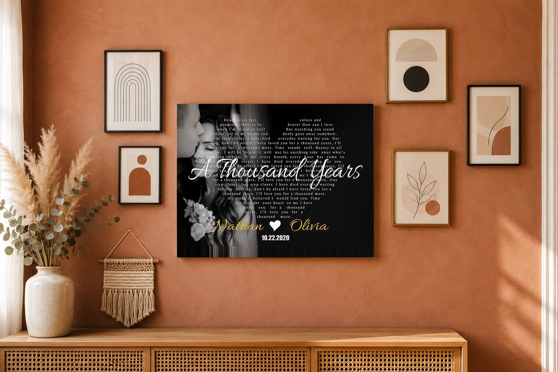 Custom couple names and date song lyrics canvas on a terracotta boho gallery wall with pampas grass and eucalyptus