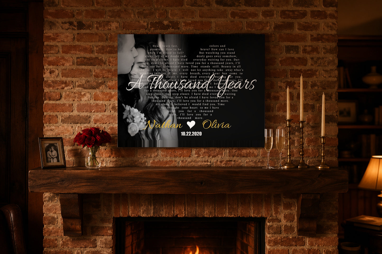 Wedding anniversary song lyrics canvas above a brick fireplace mantel with red roses, champagne flutes and brass candles