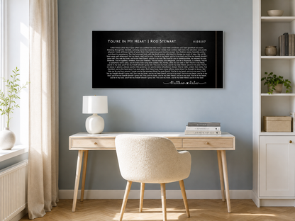 Personalized music canvas above a white oak desk in a bright blue-grey scandinavian home office