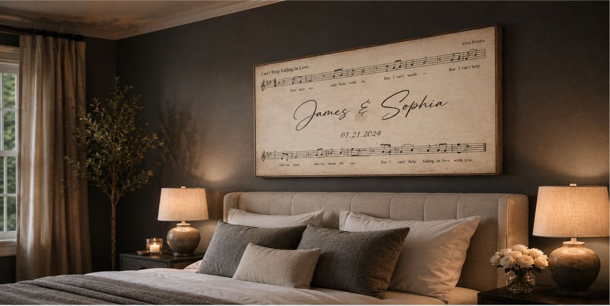 Angled view of a custom sheet music song lyrics canvas hanging over an upholstered headboard, first dance song personalized with names and anniversary date on aged parchment