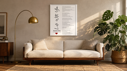 Custom song lyrics print displayed above a mid-century sofa in a sunlit living room