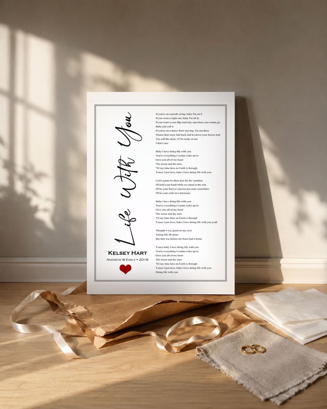 Personalized song lyrics canvas unwrapped as a wedding gift with kraft paper, ribbon and wedding rings