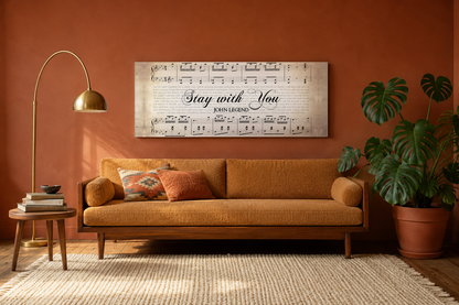 Stay with You by John Legend song lyrics canvas hanging above an ochre mid-century sofa in a warm terracotta living room