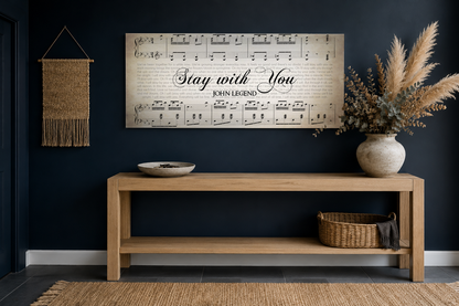 Stay with You lyrics canvas above a light oak entryway console with pampas grass against a deep navy wall