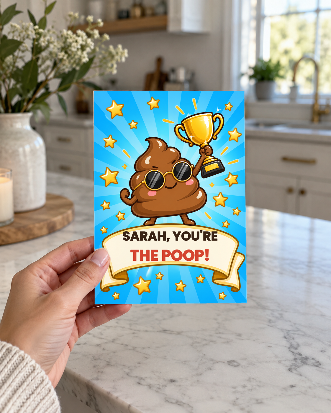 Hand holding the You're the Poop card in a kitchen
