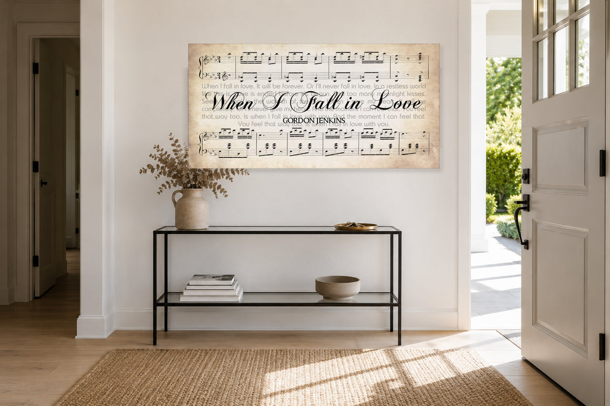 When I Fall in Love panoramic canvas above a slim black console in a sunlit entryway