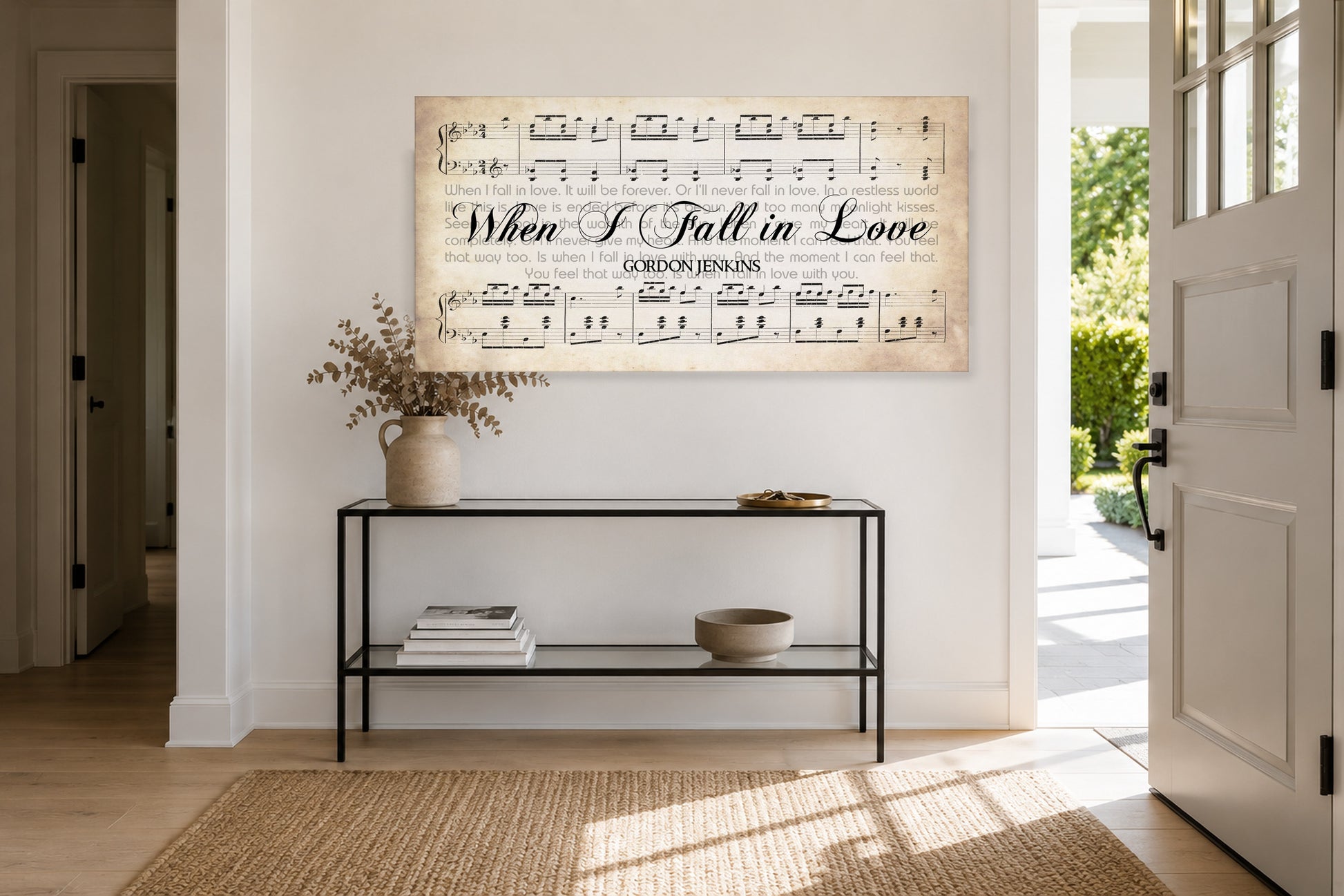 When I Fall in Love panoramic canvas above a slim black console in a sunlit entryway